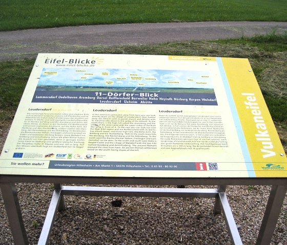 Information sign about the Eifelblick in Leudersdorf with text and panoramic view of the surrounding area. It describes the 11-village view in the Volcanic Eifel., © Touristik GmbH Gerolsteiner Land, Ute Klinkhammer Information sign about the Eifelblick in Leudersdorf with text and panoramic view of the surrounding area. It describes the 11-village view in the Volcanic Eifel., © Touristik GmbH Gerolsteiner Land, Ute Klinkhammer