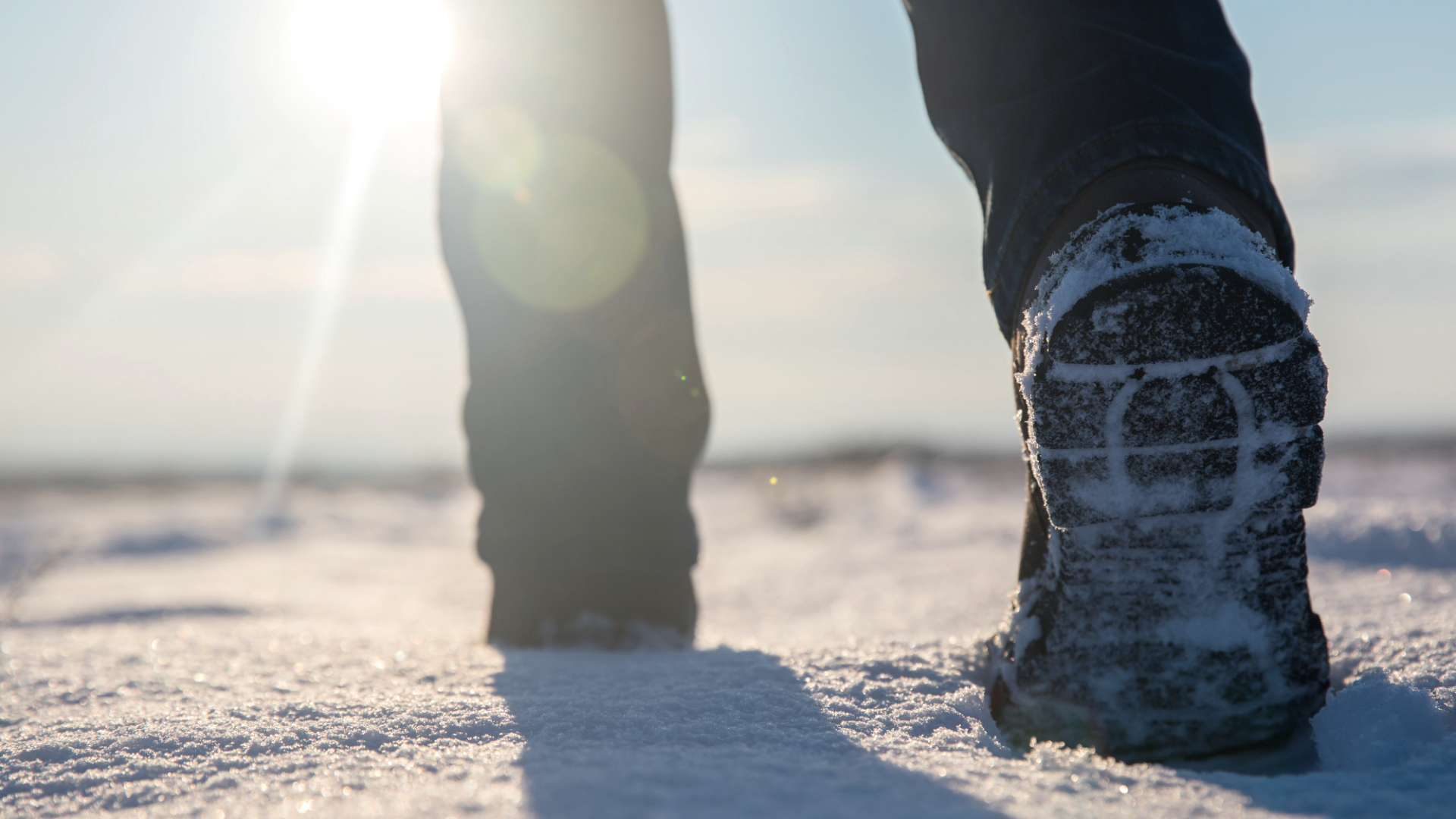 Hikers in the snow
, © Canva Frog's-eye view of people hiking across a thick blanket of snow. The sun is shining brightly in the sky.