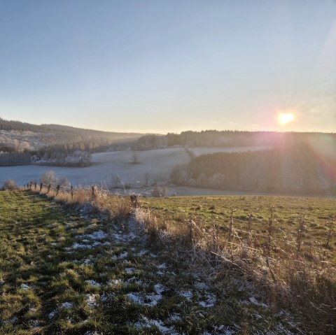 Winter landscape in Gerolsteiner Land, © Touristik GmbH Gerolsteiner Land Hilly meadow landscape lightly covered with snow and sunset in the background.