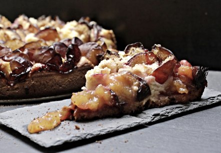 A slice of plum tart.
, © Pixabay A slice of plum tart served on a slate plate. Next to it, the rest of the tart.