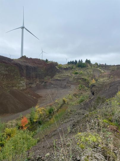 Ici, on a une vue sur le volcan. On voit des collines légèrement recouvertes de végétation. Le ciel est nuageux.