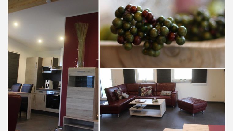 Eine moderne Wohnküche mit stilvollem Design und einer gemütlichen Sitzecke. Im Fokus steht eine Schüssel mit frischen Trauben.