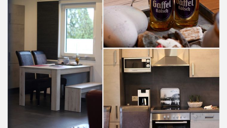 Eine moderne Küche mit einem Essbereich und einem Tisch. Auf der Arbeitsfläche stehen zwei Flaschen Bier und einige Zutaten.