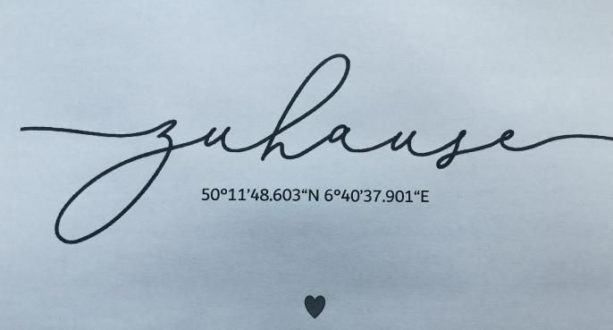 A stylish inscription with the word "home" and the geographical coordinates below. A simple yet meaningful design.