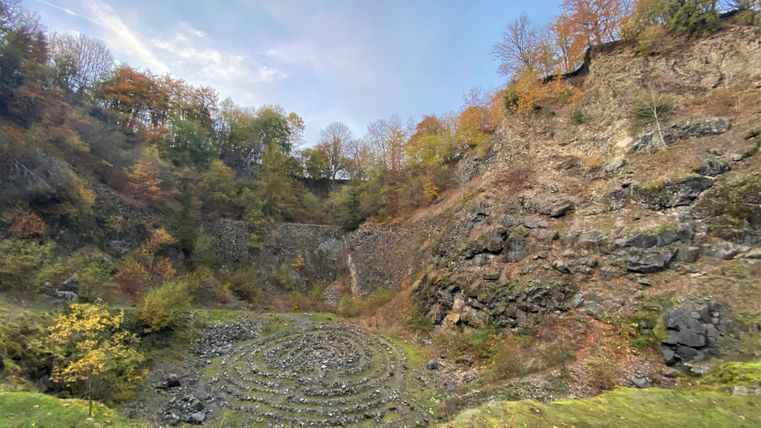 Inside the massive volcanic quarry in an autumnal rocky landscape.