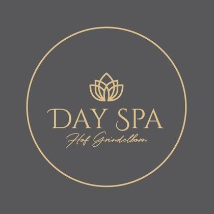 Un logo élégant pour un spa de jour avec une fleur de lotus stylisée. Le texte est en or sur un fond gris.