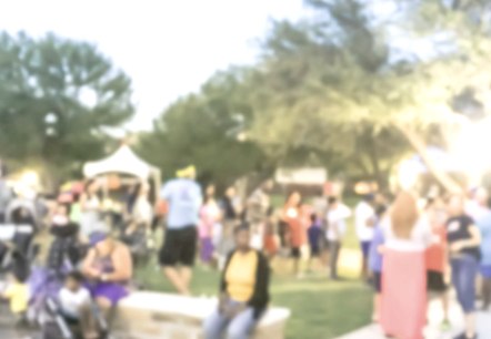 Blurry photo of a park with lots of people in it.