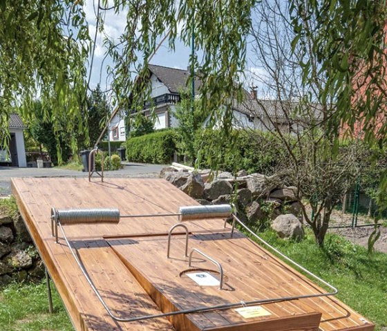 Large wooden mousetrap outdoors, surrounded by trees and houses. The trap has been recreated true to detail., © Christiane Weides