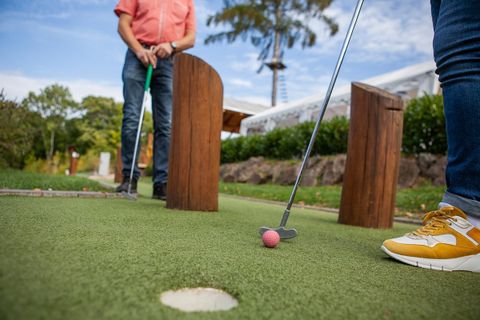 zwei Personen, die Minigolf spielen