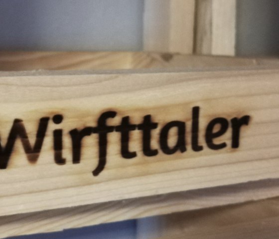 Holzbalken mit eingebranntem Schriftzug "Wirfttaler"
