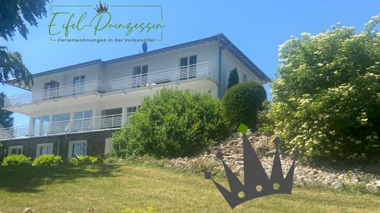 A modern holiday home surrounded by green landscape. The terrace offers a beautiful view of nature.